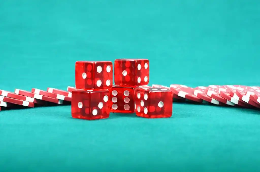 Three Card Poker live table interface on mobile showing dealer cards and bet buttons